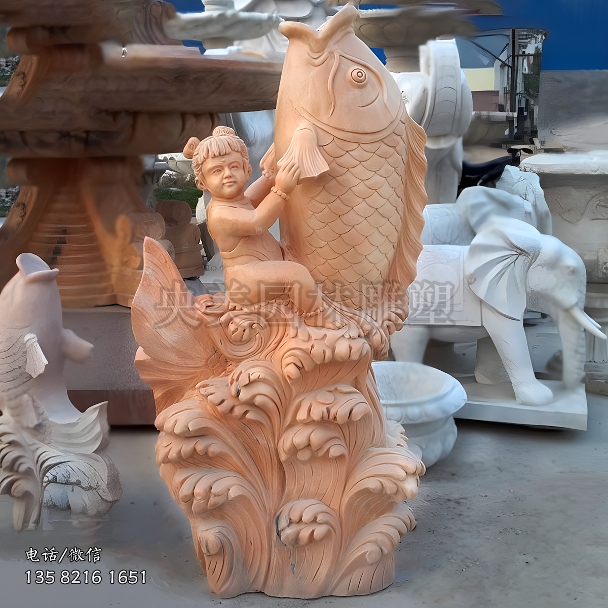 馱著一個(gè)孩子的躍水鯉魚(yú)石雕